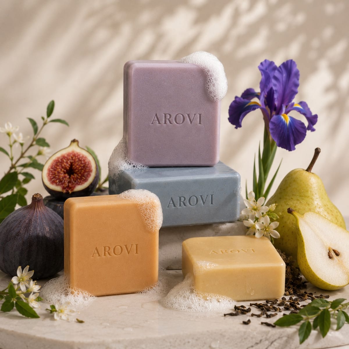 Four colored AROVI botanical soap bars arranged with floral and fruit elements