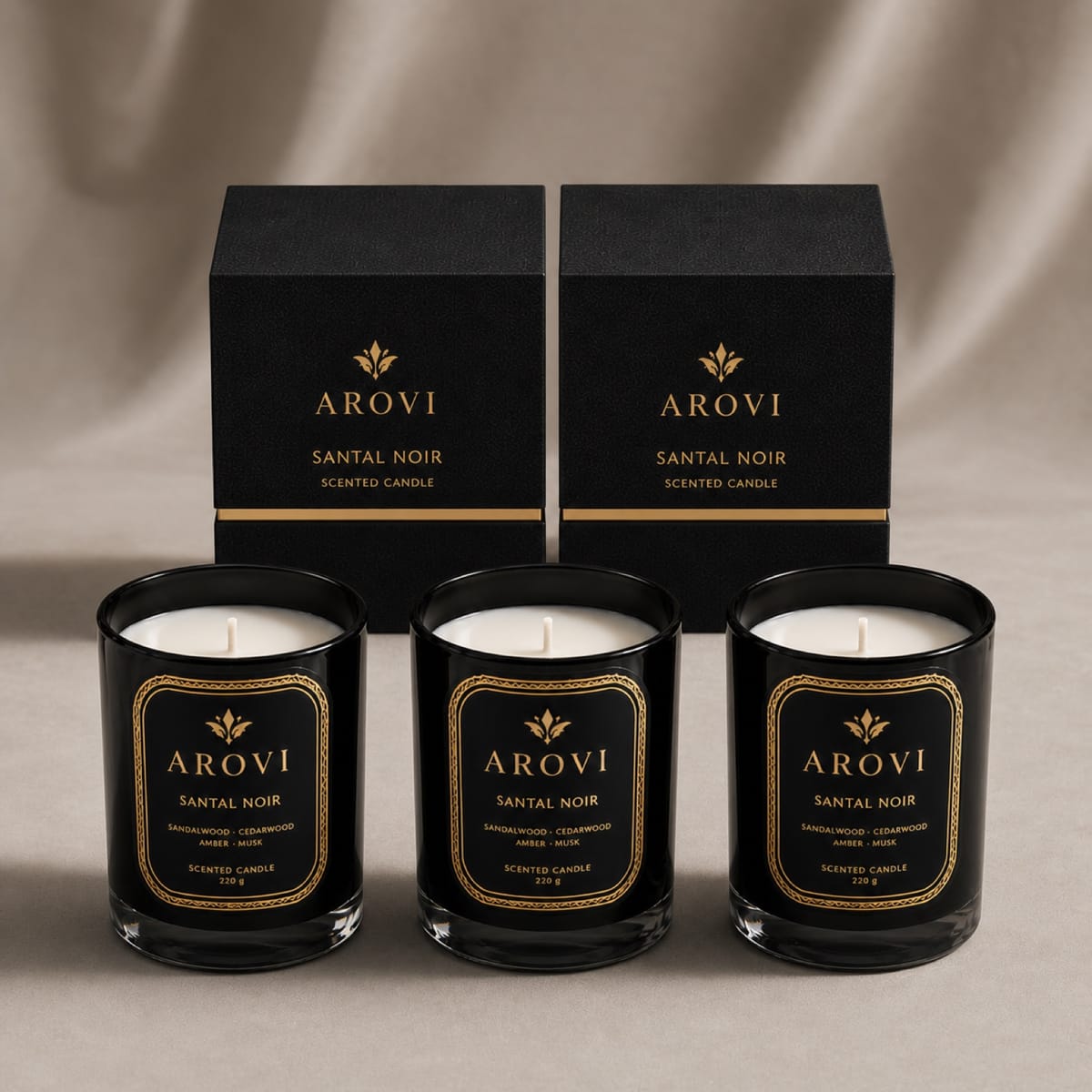 Black glass candles displayed with black and gold gift boxes