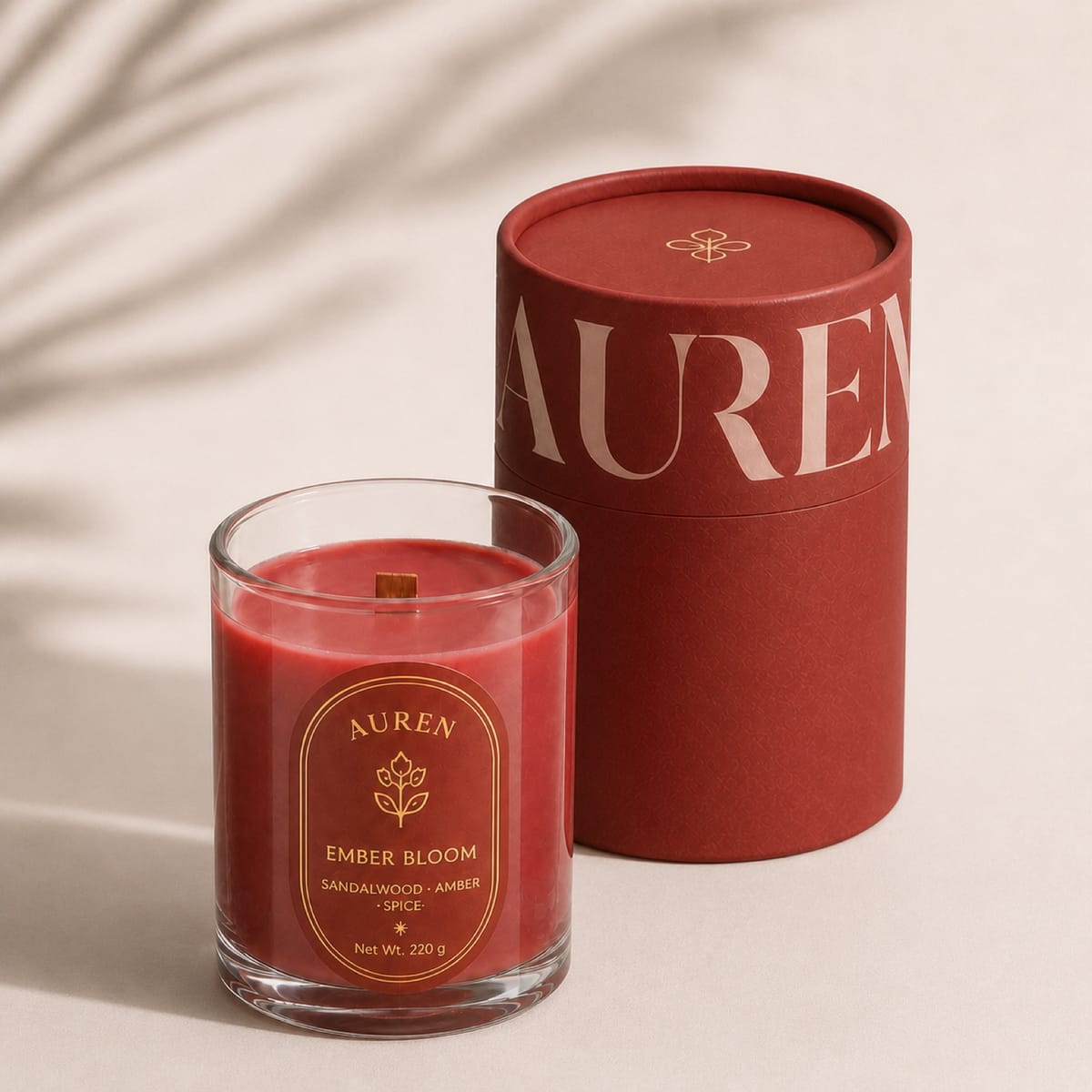 Red wooden-wick candle beside a red tube box