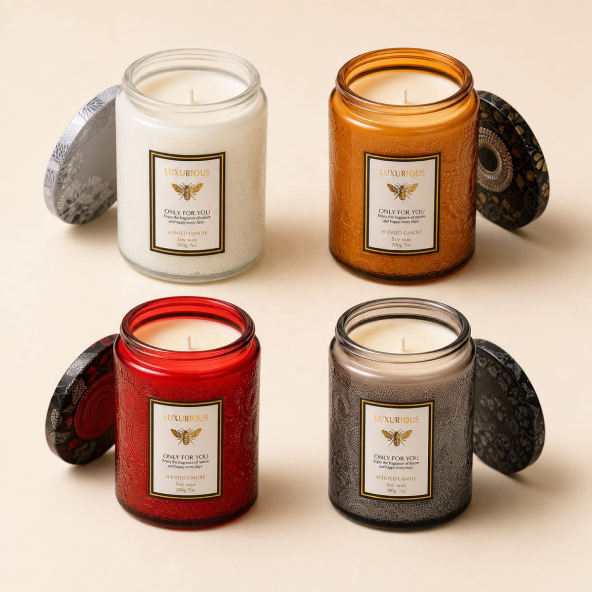 Four embossed glass jar candles in clear, amber, red and smoke finishes