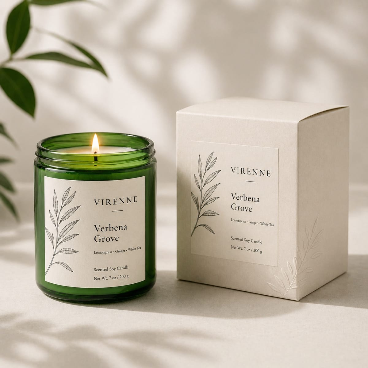 Lit green glass candle beside a light-colored carton